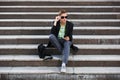 Young handsome business man using cell phone sitting on steps Royalty Free Stock Photo