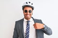 Young handsome business man wearing bike helmet and sunglasses over isolated background with surprise face pointing finger to Royalty Free Stock Photo