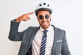 Young handsome business man wearing bike helmet and sunglasses over isolated background very happy pointing with hand and finger Royalty Free Stock Photo