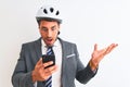 Young handsome business man wearing bike helmet using smartphone over isolated background very happy and excited, winner Royalty Free Stock Photo