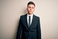 Young handsome business man wearing elegant suit and tie over isolated background looking at the camera blowing a kiss on air Royalty Free Stock Photo