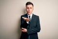 Young handsome business man wearing elegant suit and tie over isolated background looking at the camera blowing a kiss with hand Royalty Free Stock Photo