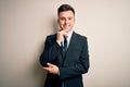 Young handsome business man wearing elegant suit and tie over isolated background looking confident at the camera smiling with Royalty Free Stock Photo