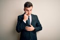 Young handsome business man wearing elegant suit and tie over isolated background Pointing to the eye watching you gesture, Royalty Free Stock Photo