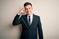 Young handsome business man wearing elegant suit and tie over isolated background Smiling pointing to head with one finger, great Royalty Free Stock Photo