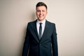 Young handsome business man wearing elegant suit and tie over isolated background winking looking at the camera with sexy Royalty Free Stock Photo