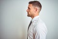 Young handsome business man wearing elegant white shirt over isolated background looking to side, relax profile pose with natural Royalty Free Stock Photo