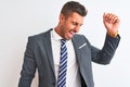 Young handsome business man wearing suit and tie over isolated background Dancing happy and cheerful, smiling moving casual and Royalty Free Stock Photo