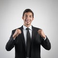 Young handsome businessman in black suit smiling on white background. Portrait of young business man. Royalty Free Stock Photo