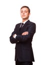 Young handsome businessman in black suit is standing straight with crossed arms, full length portrait isolated on white Royalty Free Stock Photo
