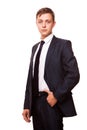 Young handsome businessman in black suit is standing straight, portrait isolated on white background Royalty Free Stock Photo