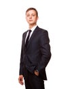 Young handsome businessman in black suit is standing straight, portrait isolated on white background Royalty Free Stock Photo