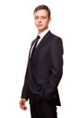 Young handsome businessman in black suit is standing straight, portrait isolated on white background Royalty Free Stock Photo