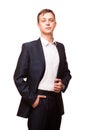 Young handsome businessman in black suit is standing straight and putting his hands in pockets, portrait isolated on Royalty Free Stock Photo