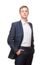 Young handsome businessman in black suit is standing straight and putting his hands in pockets, portrait isolated on Royalty Free Stock Photo