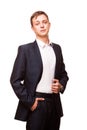 Young handsome businessman in black suit is standing straight and putting his hands in pockets, portrait isolated on Royalty Free Stock Photo