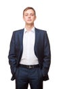 Young handsome businessman in black suit is standing straight and putting his hands in pockets, portrait isolated on Royalty Free Stock Photo