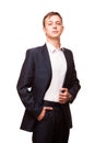 Young handsome businessman in black suit is standing straight and putting his hands in pockets, portrait isolated on Royalty Free Stock Photo