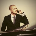 Young handsome businessman calling on phone next to his car Royalty Free Stock Photo