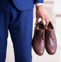 Young handsome businessman choosing shoes at home Royalty Free Stock Photo