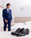 Young handsome businessman choosing shoes at home Royalty Free Stock Photo