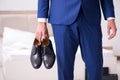 The young handsome businessman choosing shoes at home Royalty Free Stock Photo