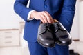 Young handsome businessman choosing shoes at home Royalty Free Stock Photo