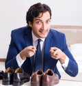 Young handsome businessman choosing shoes at home Royalty Free Stock Photo