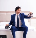 Young handsome businessman choosing shoes at home Royalty Free Stock Photo