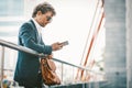 Young handsome businessman concentraited on the smartphone while he reading text message. Royalty Free Stock Photo