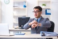 The young handsome businessman employee working in office at desk Royalty Free Stock Photo