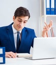 Young handsome businessman employee working in office at desk Royalty Free Stock Photo