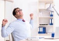 Young handsome businessman employee working in office at desk Royalty Free Stock Photo