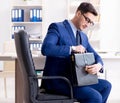 Young handsome businessman employee working in office at desk Royalty Free Stock Photo