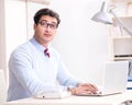 Young handsome businessman employee working in office at desk Royalty Free Stock Photo