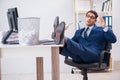 Young handsome businessman employee working in office in paperwo Royalty Free Stock Photo