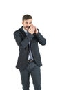 Young handsome businessman is on phone talk creating gossips. Isolated on white background. Concept of corporate secret