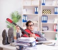 Young handsome businessman playing guitar in the office Royalty Free Stock Photo