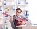 Young handsome businessman playing guitar in the office Royalty Free Stock Photo