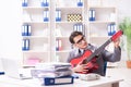 The young handsome businessman playing guitar in the office Royalty Free Stock Photo