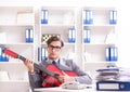 Young handsome businessman playing guitar in the office Royalty Free Stock Photo