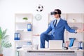 The young handsome businessman playing soccer with virtual glasses