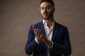 Handsome businessman rubbing his palms and looking away Royalty Free Stock Photo