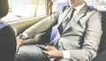 Young handsome businessman sitting in taxi cab with phone Royalty Free Stock Photo