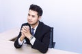 Young handsome businessman smiling and thinking at office . Royalty Free Stock Photo