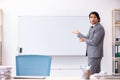 The young handsome businessman standing in front of whiteboard