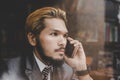 Young handsome businessman talking business with his phone while Royalty Free Stock Photo