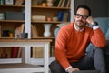 Young handsome businessman thinking business strategies while sitting on floor in living room Royalty Free Stock Photo