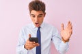 Young handsome businessman using smartphone standing over isolated pink background very happy and excited, winner expression Royalty Free Stock Photo