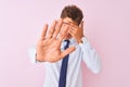 Young handsome businessman wearing shirt and tie standing over isolated pink background covering eyes with hands and doing stop Royalty Free Stock Photo
